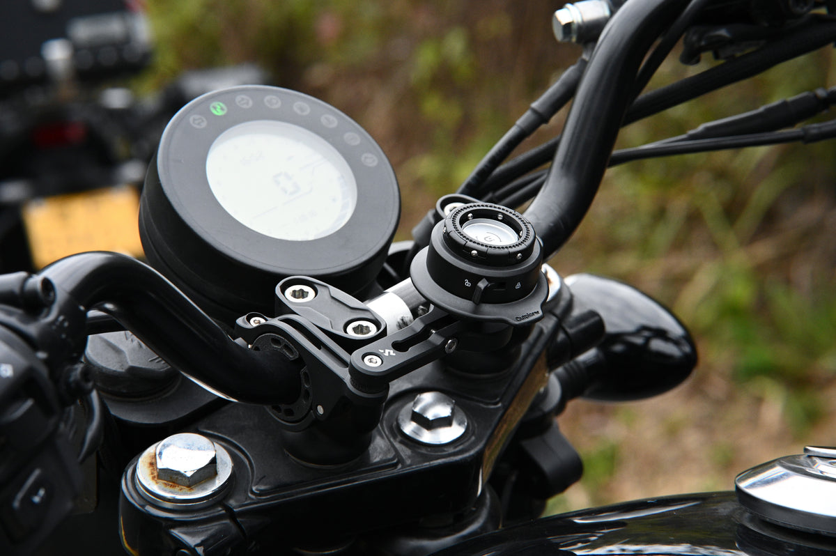 Outplorer QM02 sul manubrio di una moto: smorzatore e aggancio Quick Launch in primo piano